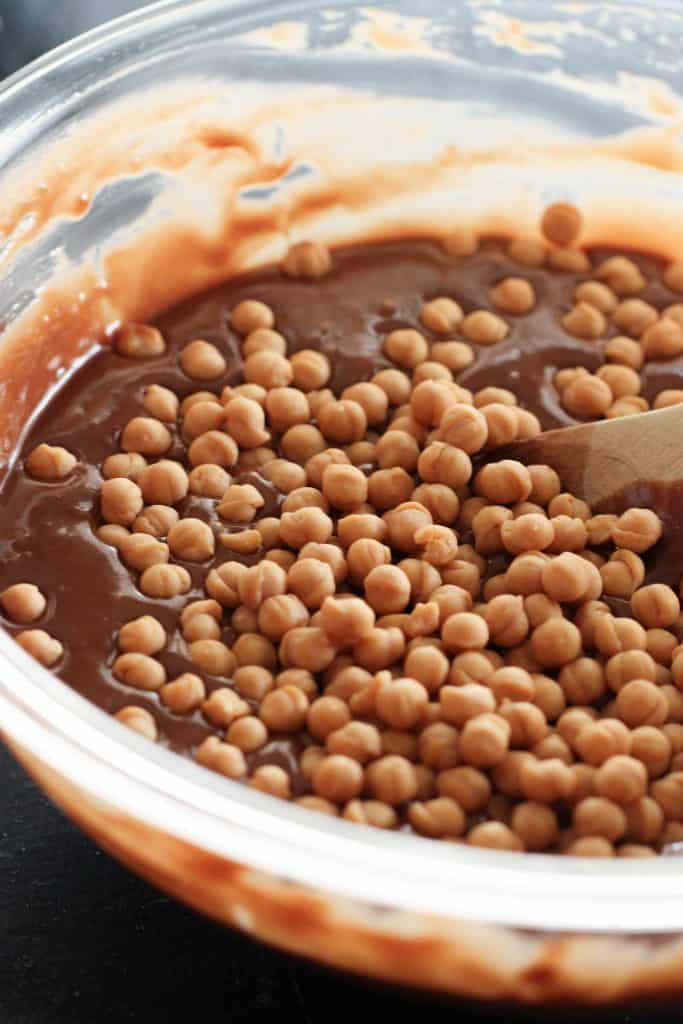 Caramel bits added to the chocolate cake batter in mixing bowl.