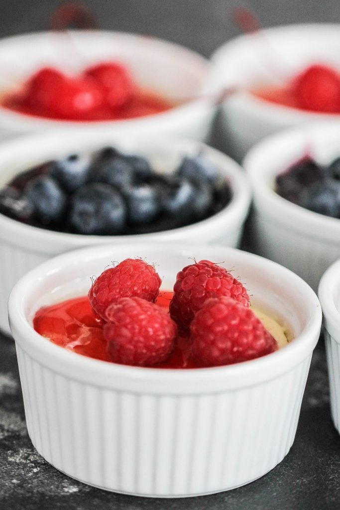 mini cheesecakes topped with raspberries and blueberries