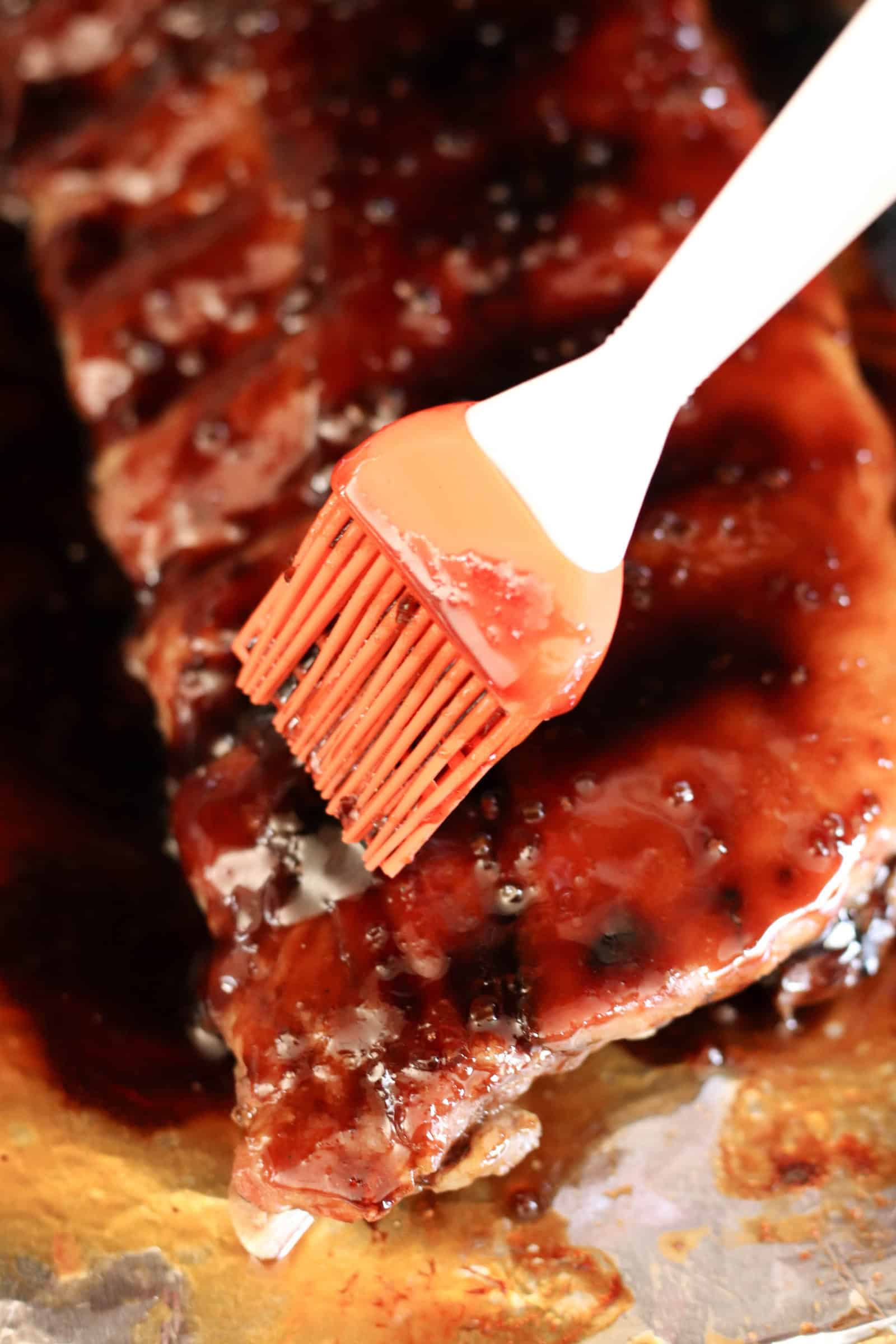 Brushing sticky sauce on ribs