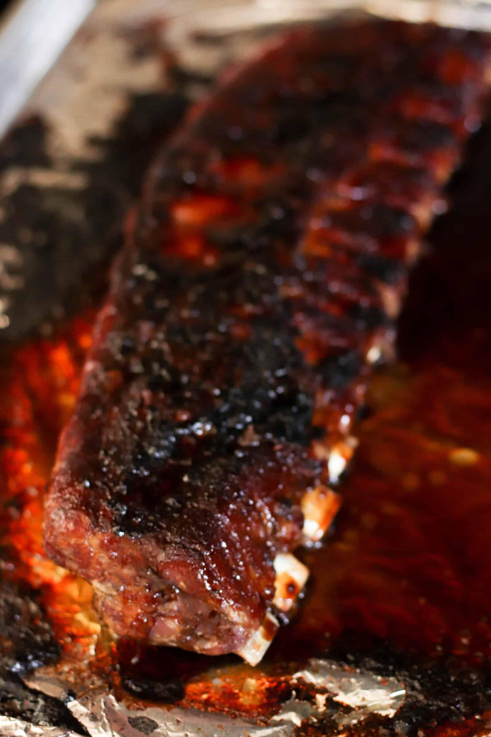 Sticky Asian Ribs on the grill on top of foil