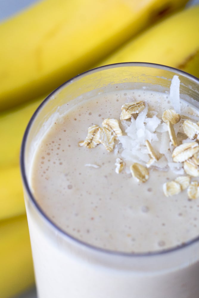 Banana Breakfast Smoothie topped with oats in a glass