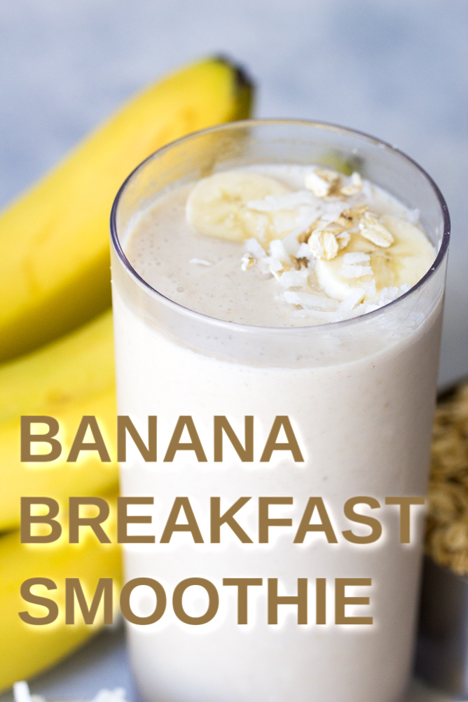 Banana Breakfast Smoothie in a glass topped with sliced banana and oats