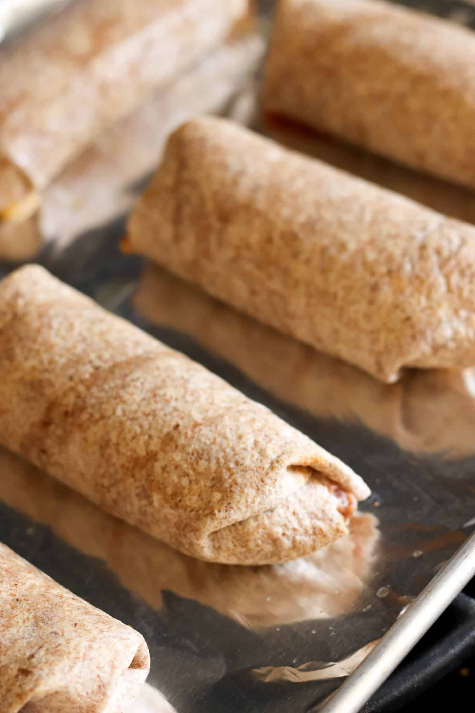 Bean and Rice Burritos on a baking sheet