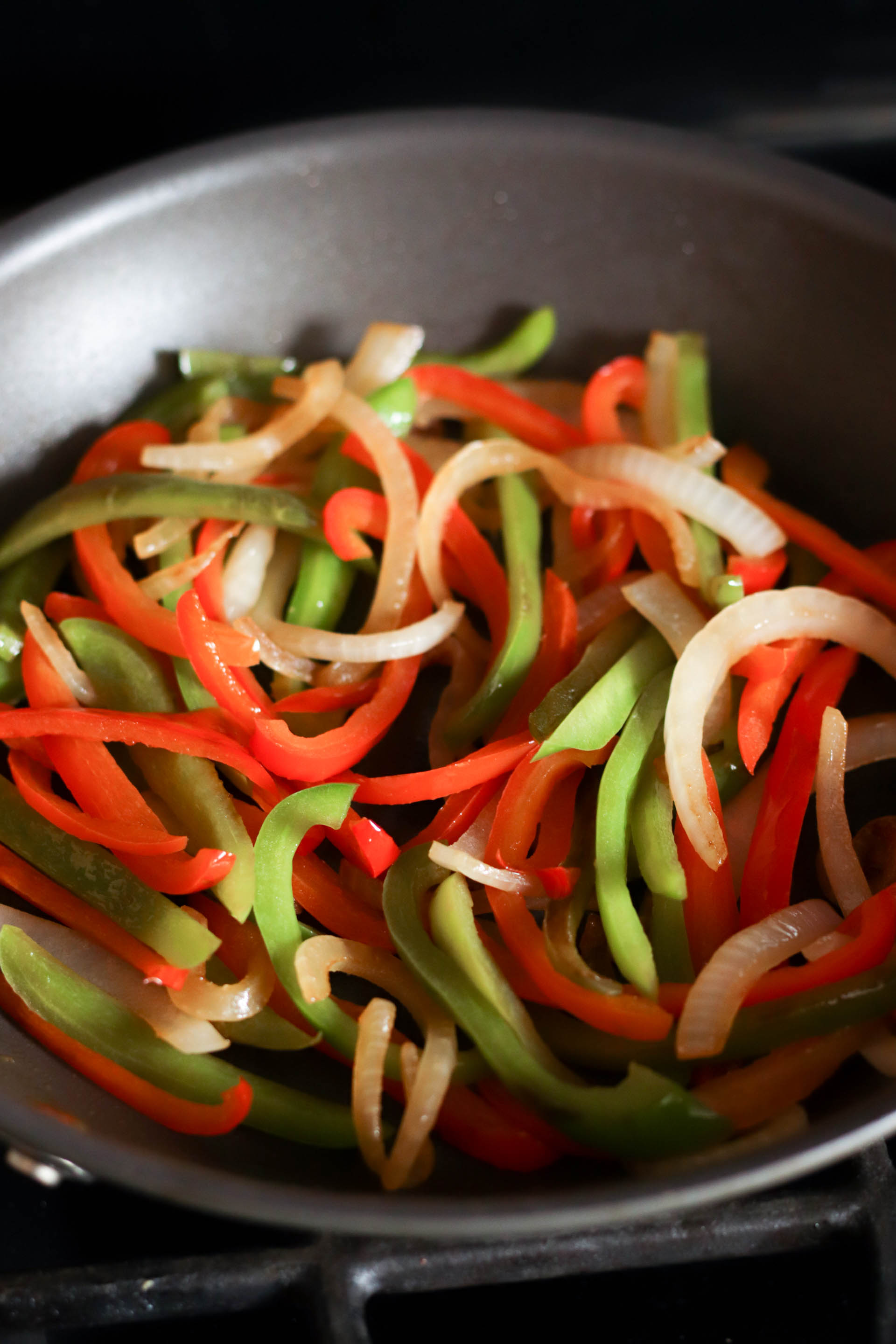 Onions and peppers in a skillet