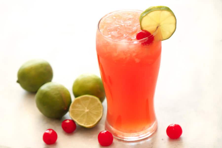 Cherry LImeade in a glass with Limes and Cherries