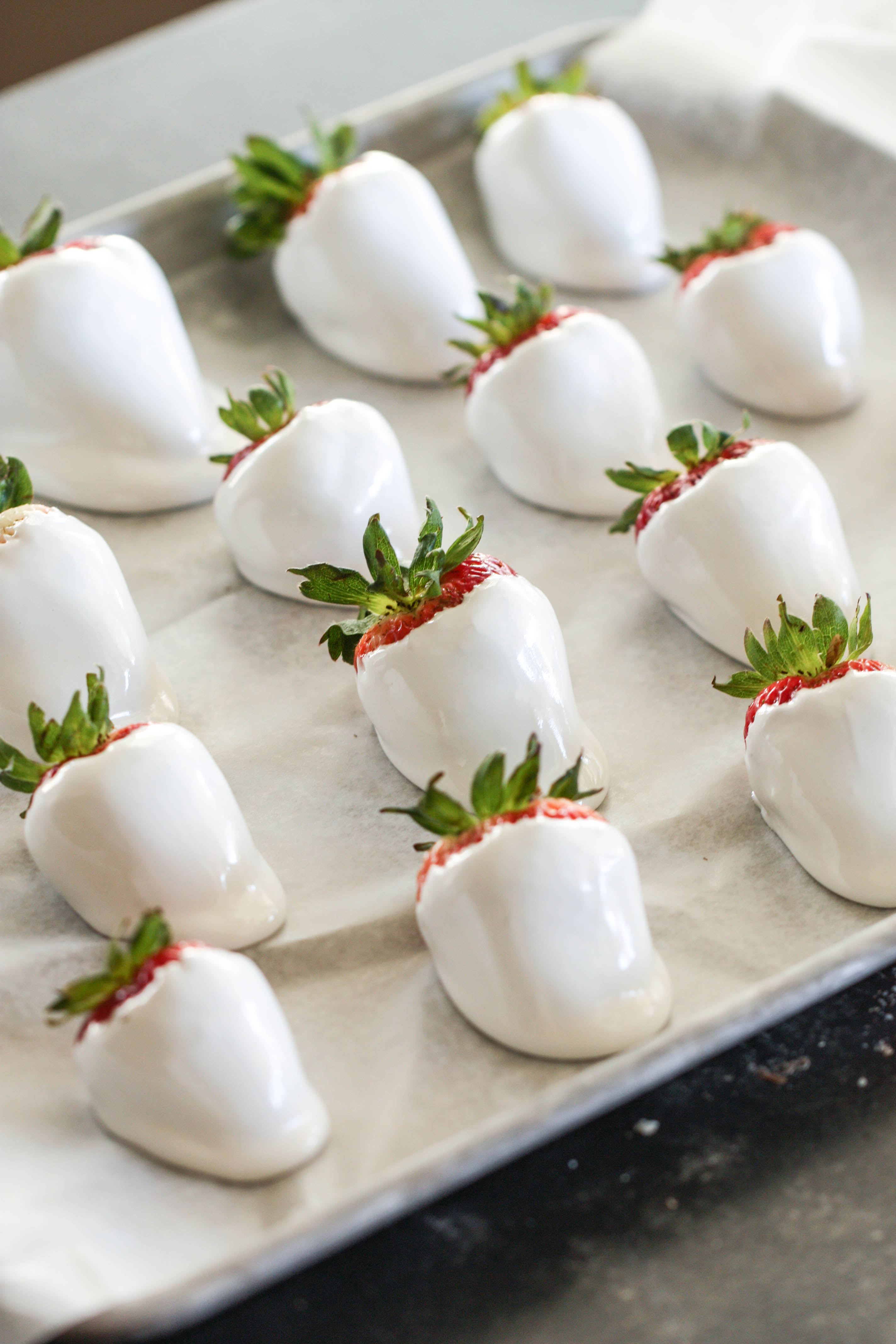 Marshmallow dipped strawberries on a sheet pan