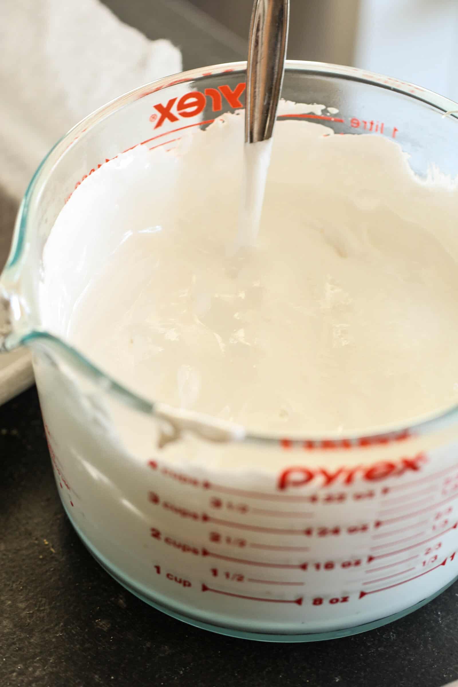 Measuring cup filled with marshmallow creme