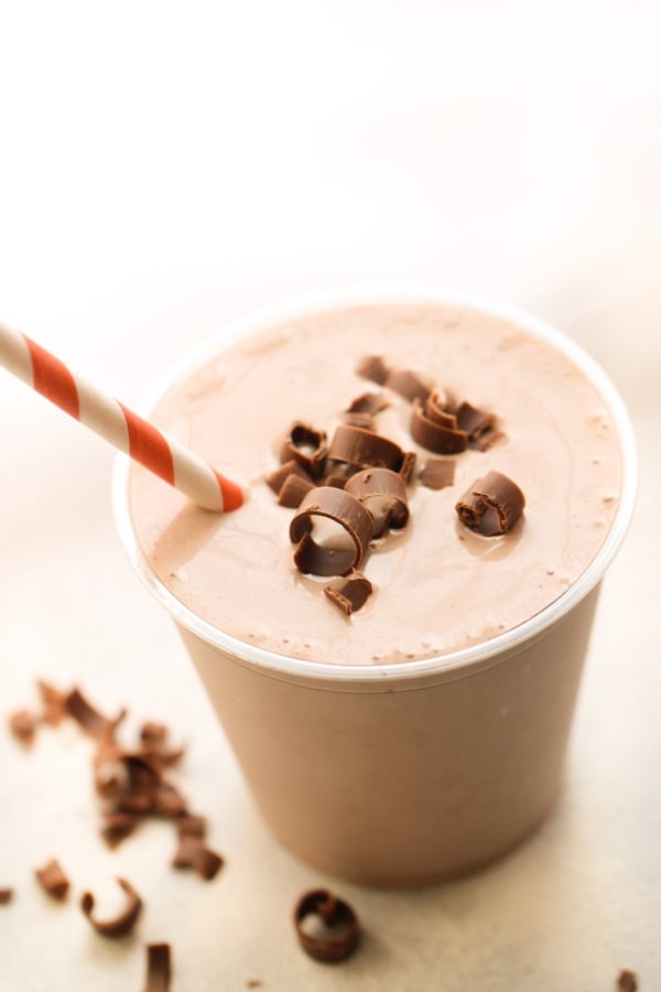 Copycat Wendy's Chocolate Frosty Recipe with chocolate shavings on top and red white strip straw