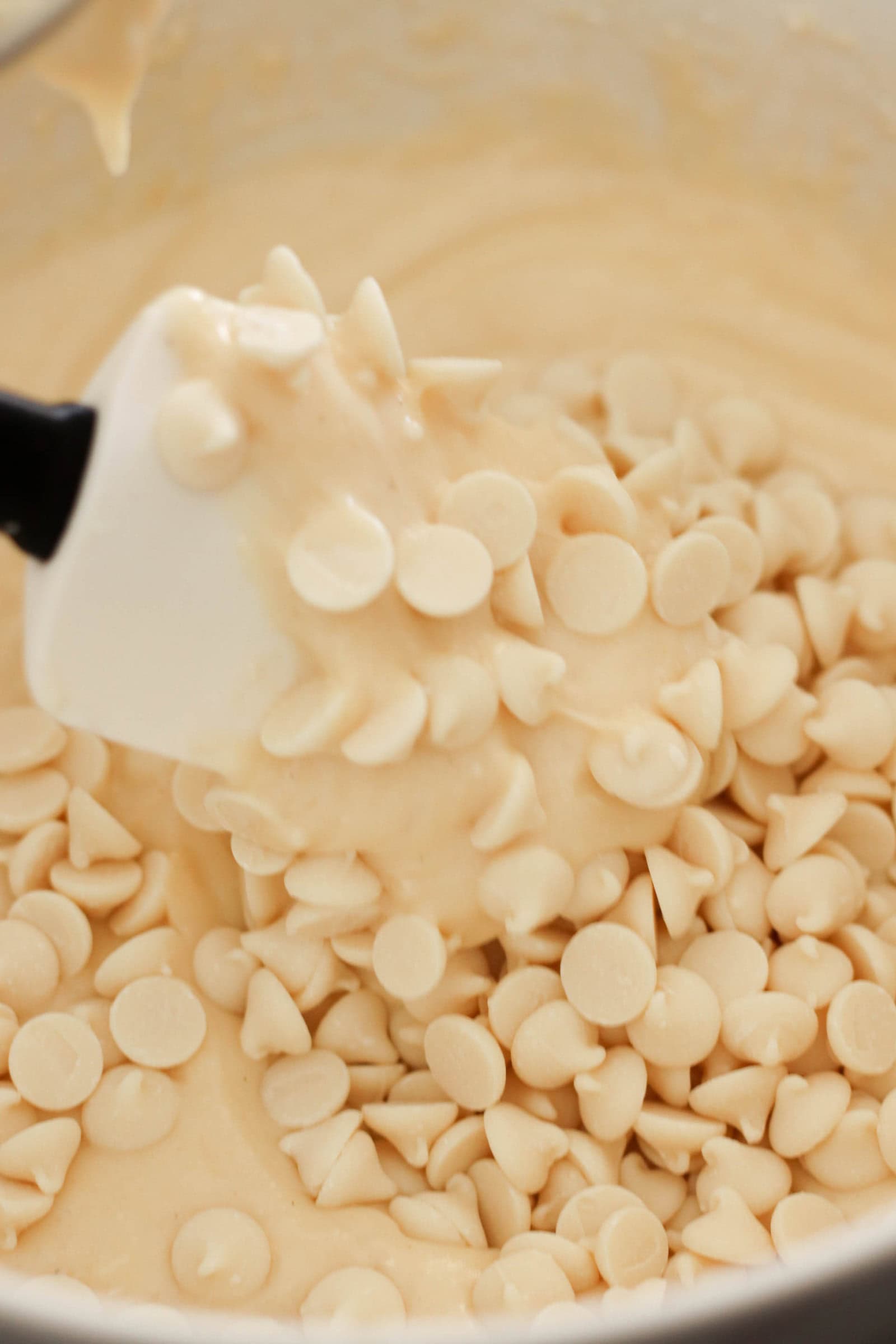 Melted White Chocolate Chips in a bowl with a spatula