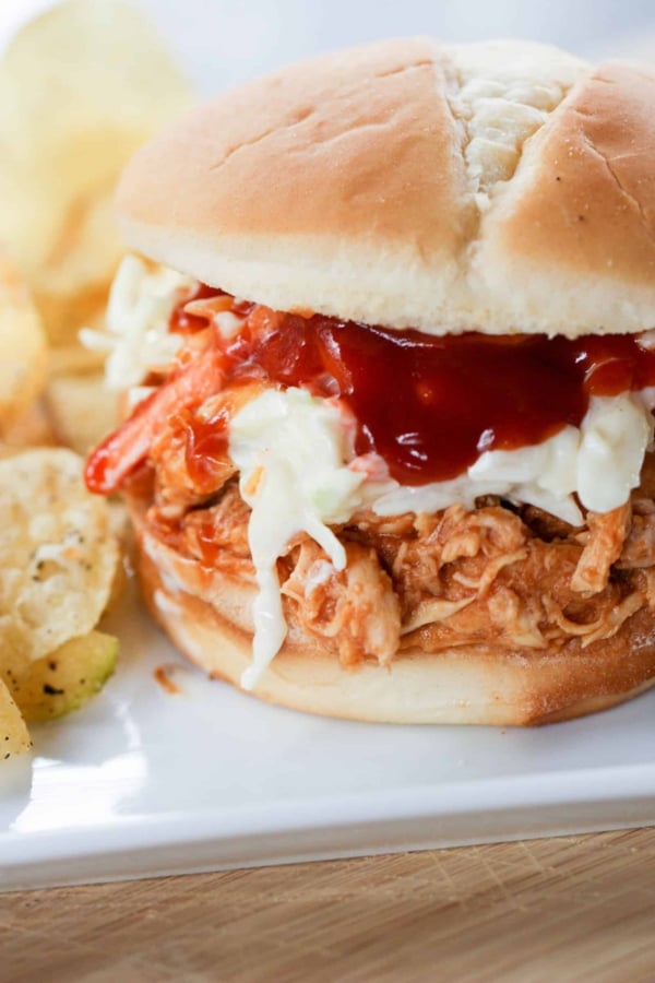 Slow Cooker Hawaiian Chicken Sandwich on a plate with chips.