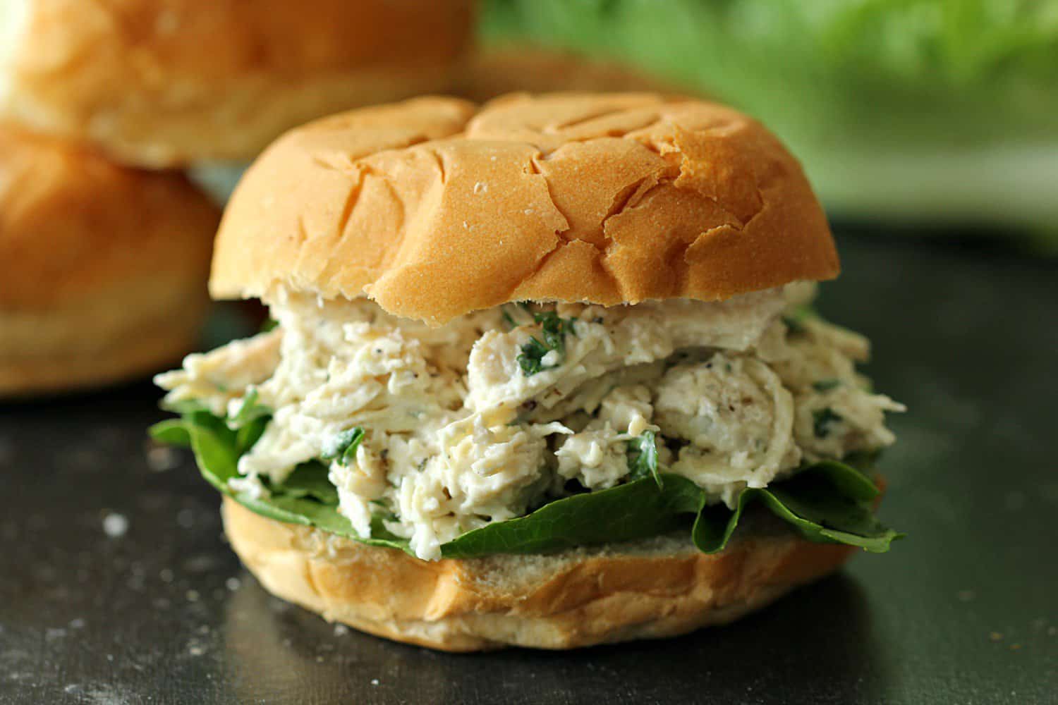 Instant Pot Chicken Caesar Sandwich on a black counter top