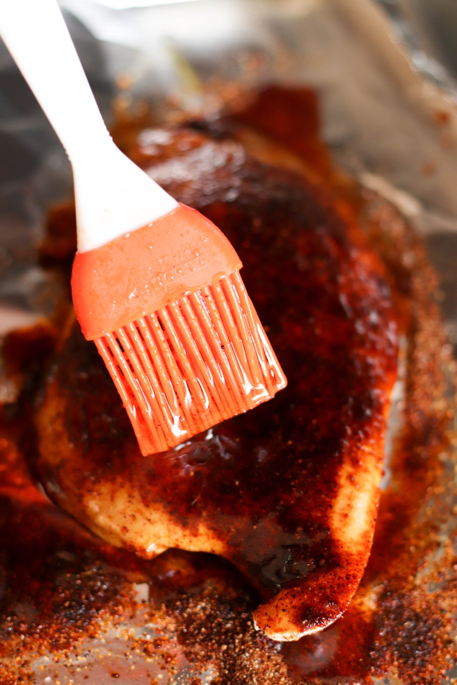 Brushing the glaze on the grilled chicken