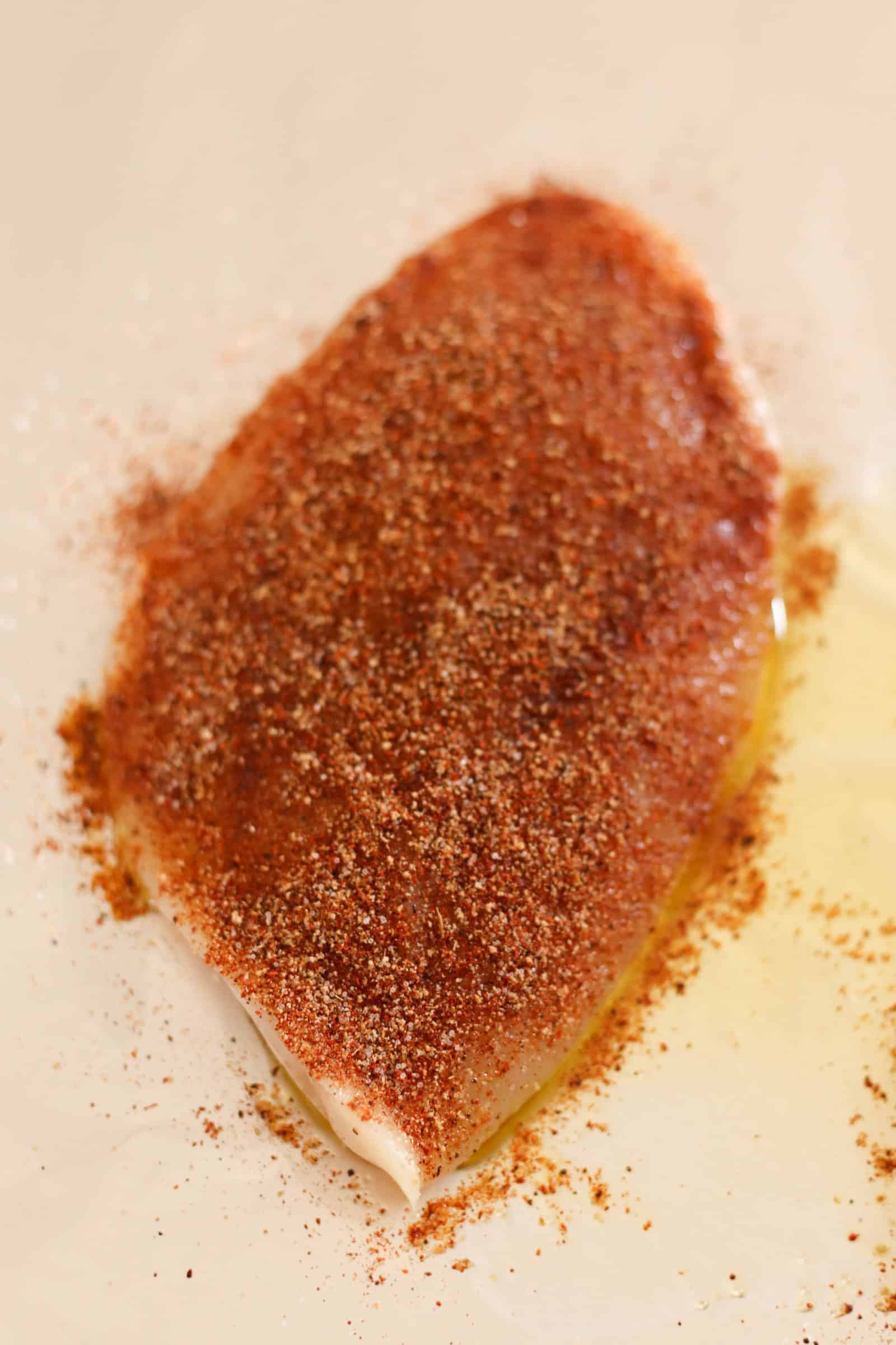 Rub spice mixture on uncooked chicken breast