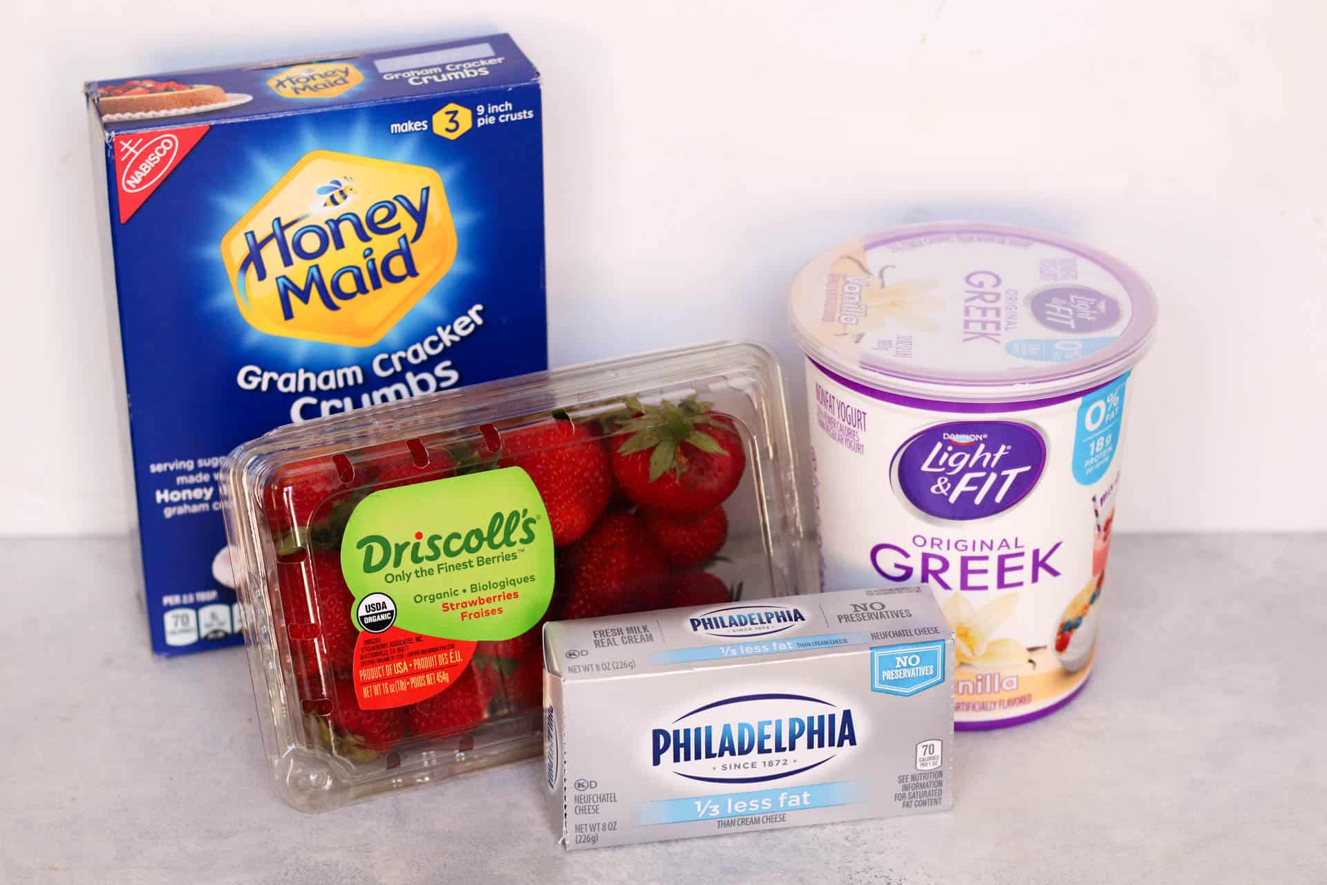Ingredients needed to make Strawberry Cheesecake Popsicles.