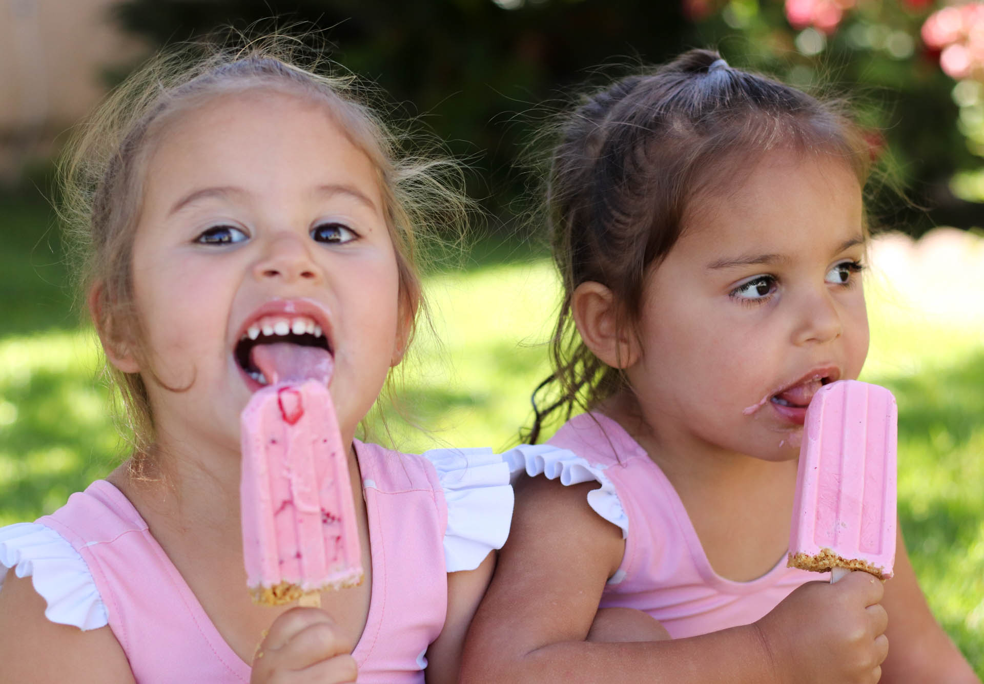 Two girls eating Strawberry Cheesecake Popsicles