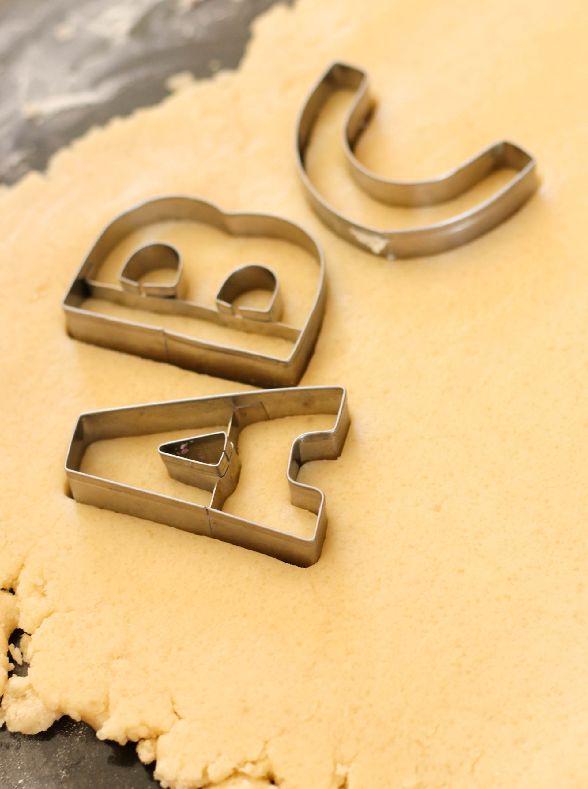 Cookie dough with alphabet cookie cutter