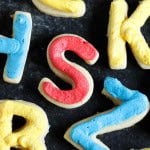 Back to school sugar cookies in the shape of letters with frosting in different colors.