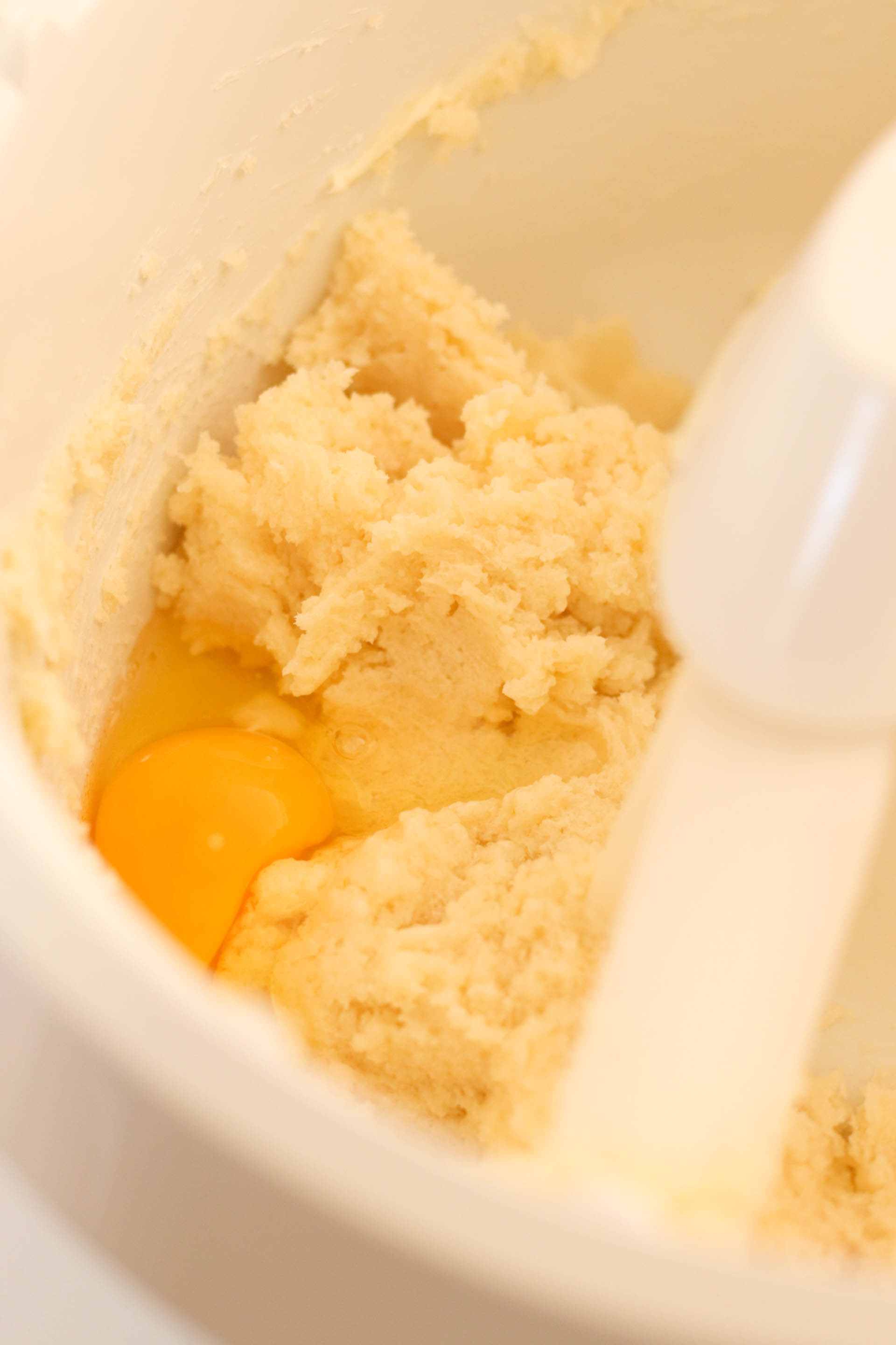 Adding eggs to cookie dough mixture in stand mixer