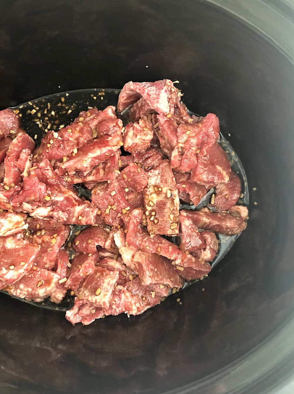 Raw Beef in the Slow Cooker seasoned