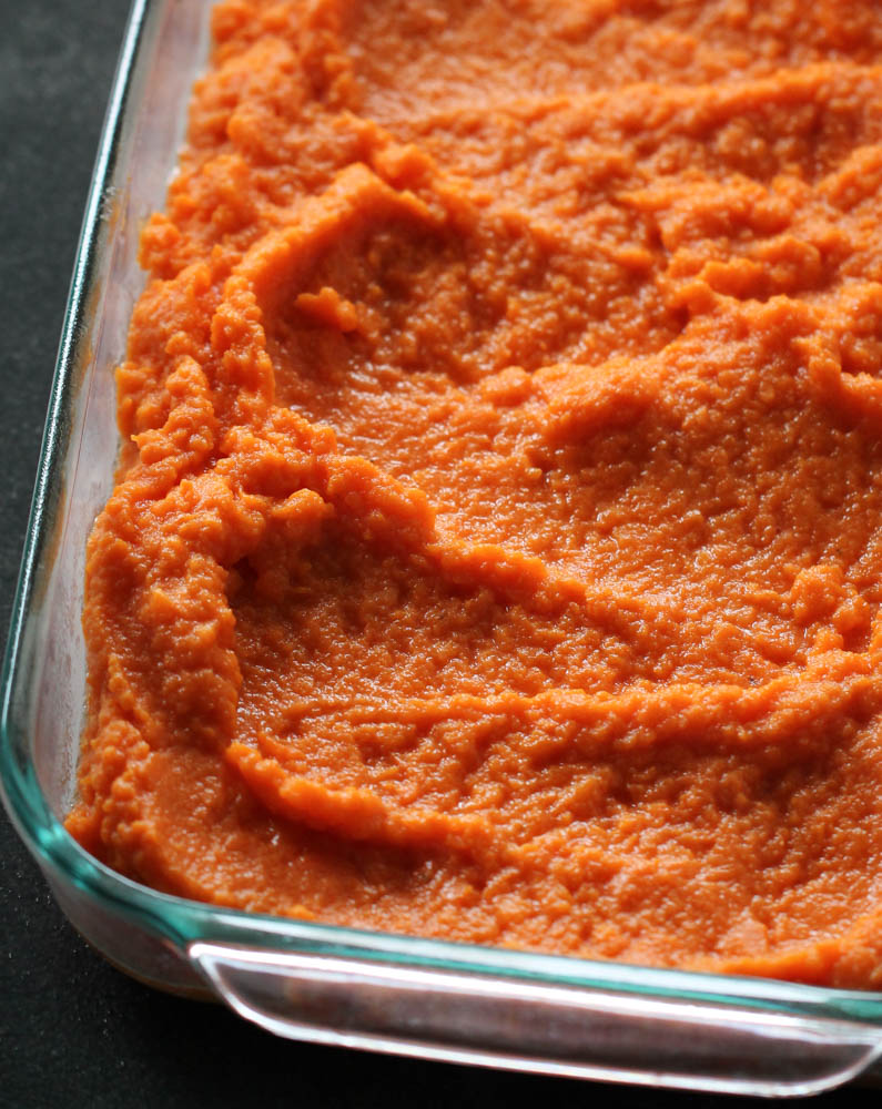 mashed sweet potatoes that are smoothed in a pan