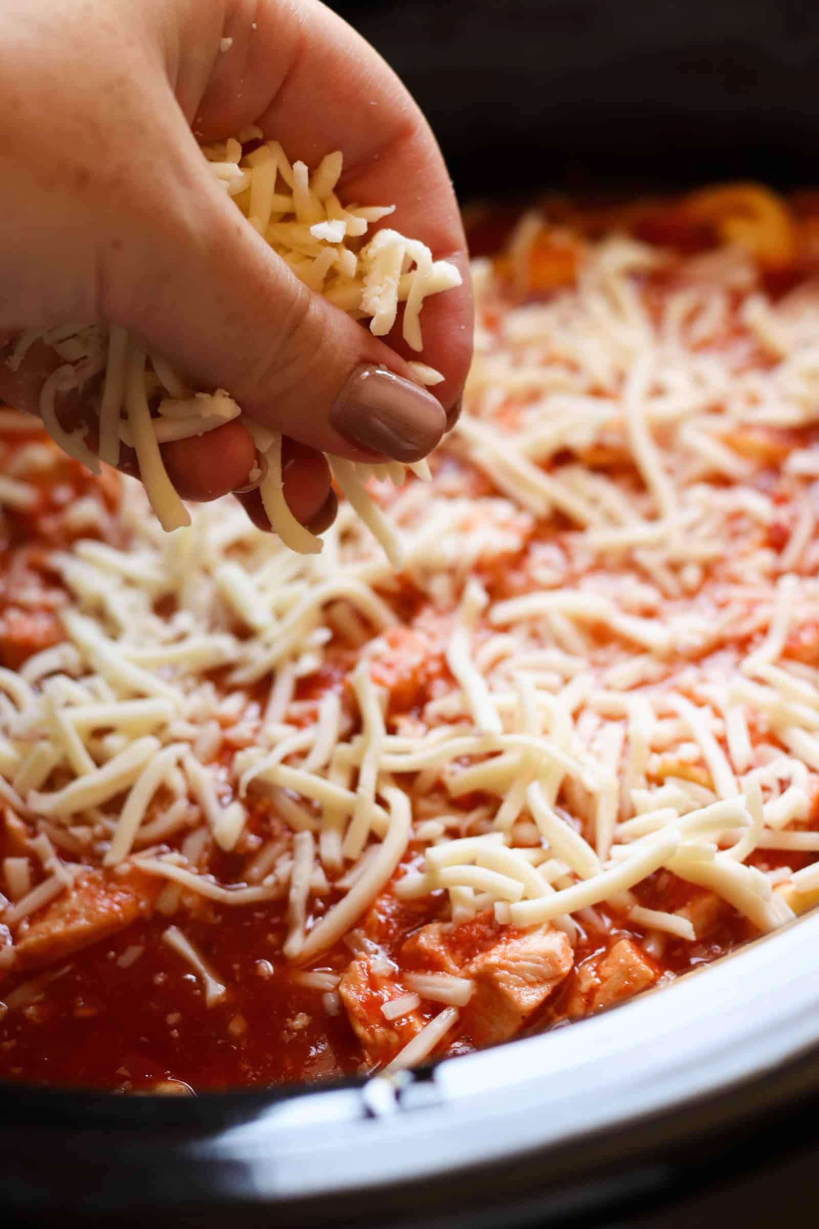 Topping slow cooker mixture with shredded cheese