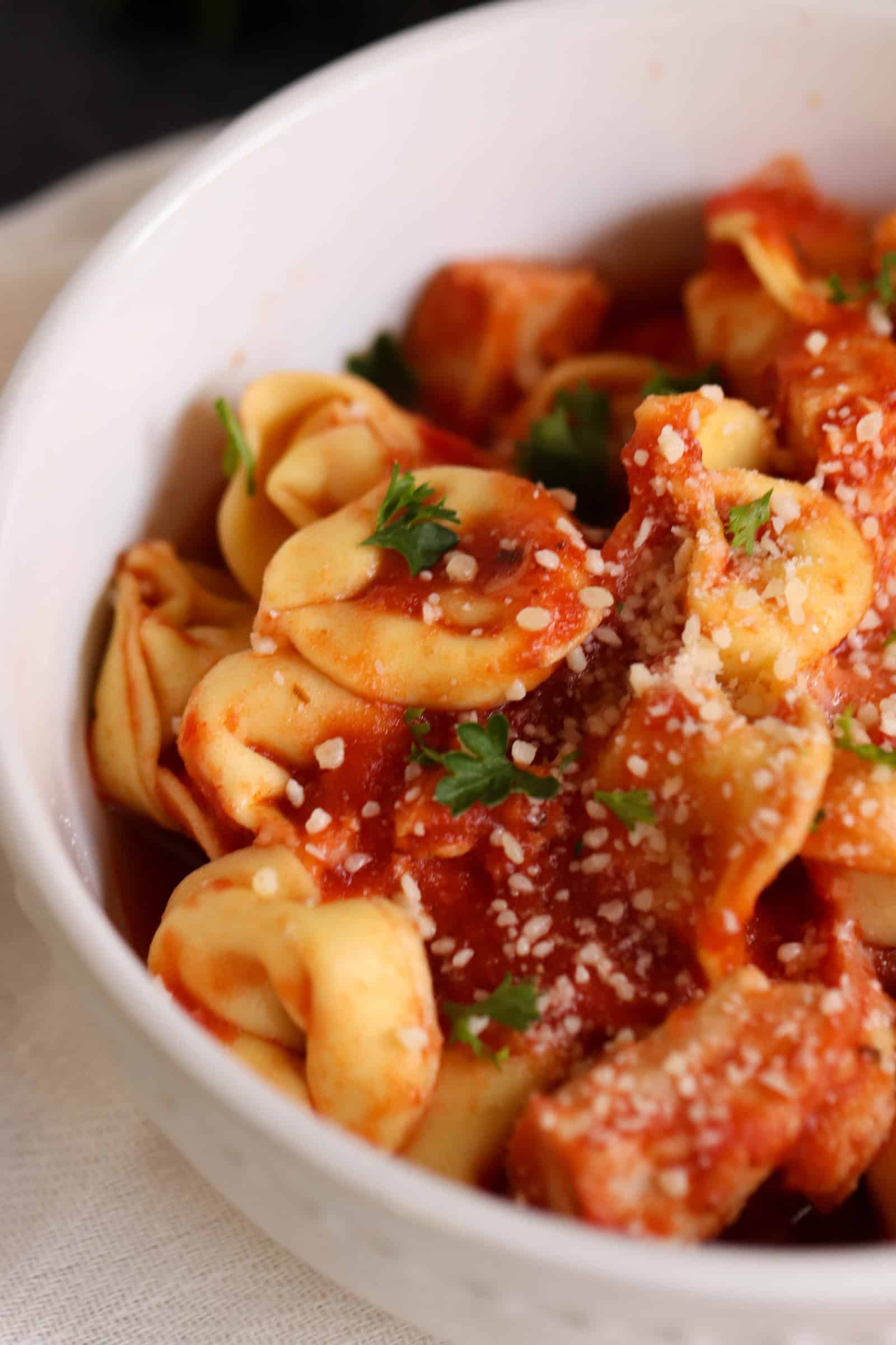 Slow Cooker Cheesy Chicken Tortellini
in a bowl topped with cheese