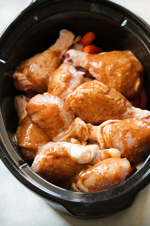 raw chicken in the slow cooker with sauce on top