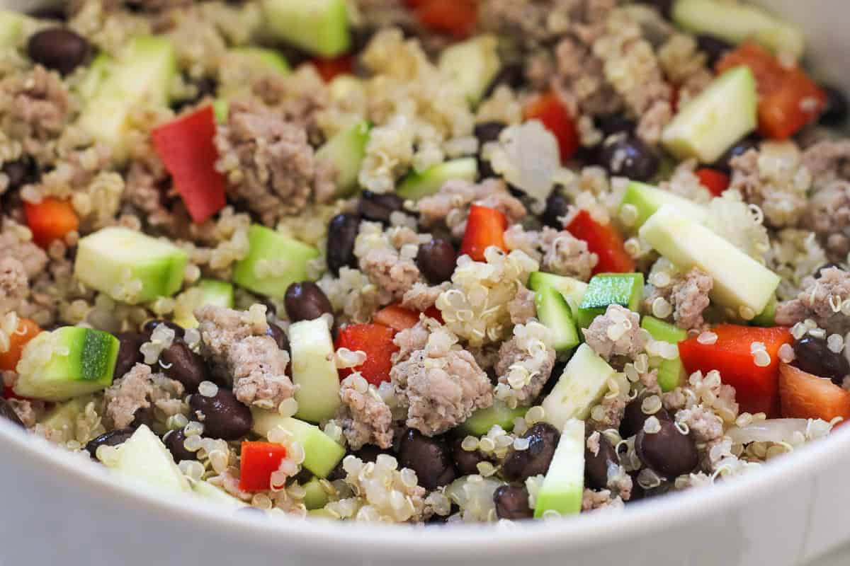 Ingredients for Zucchini Taco Casserole mixed together in a white bowl