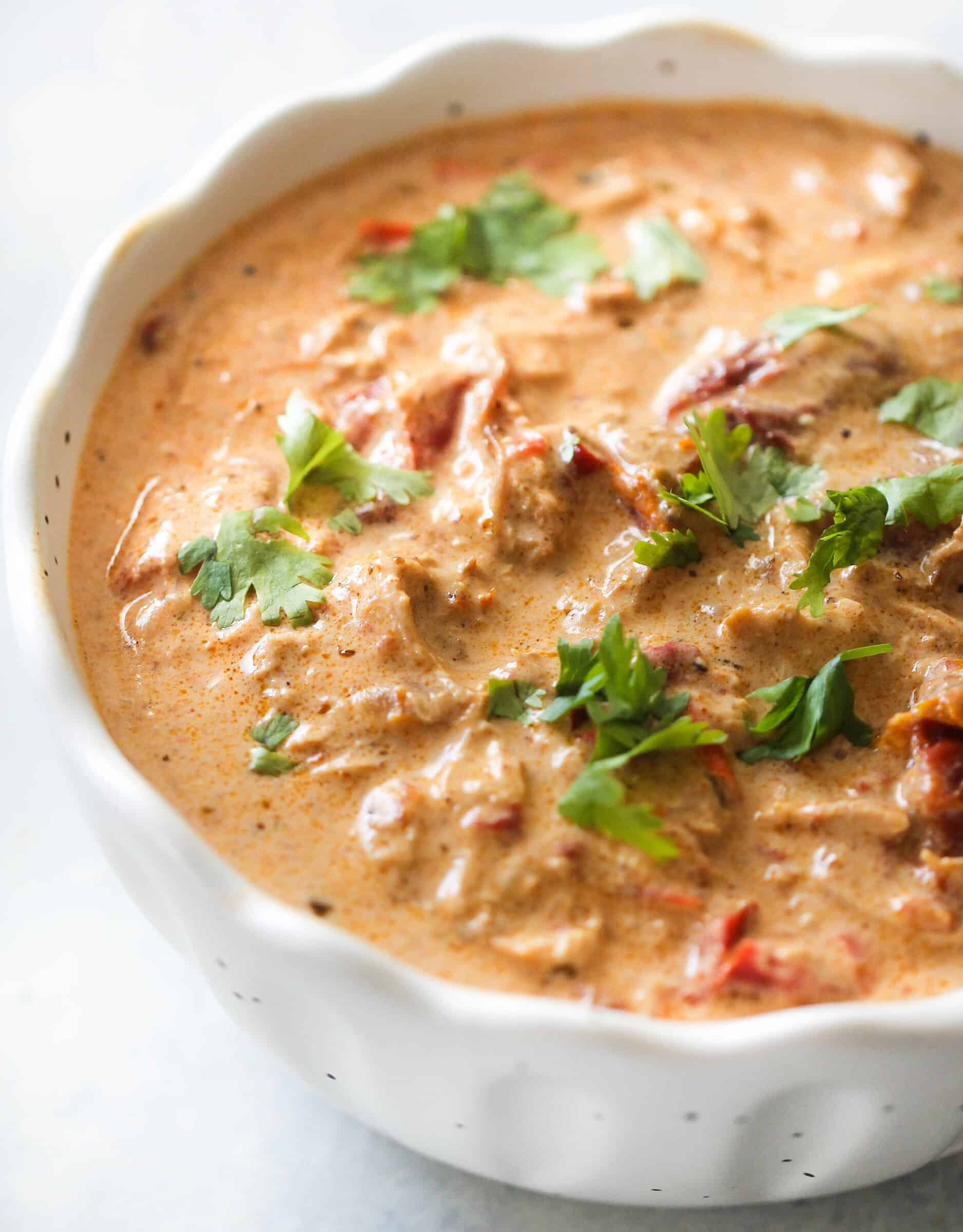 Instant Pot Creamy Chicken Soup in a white bowl with toppings