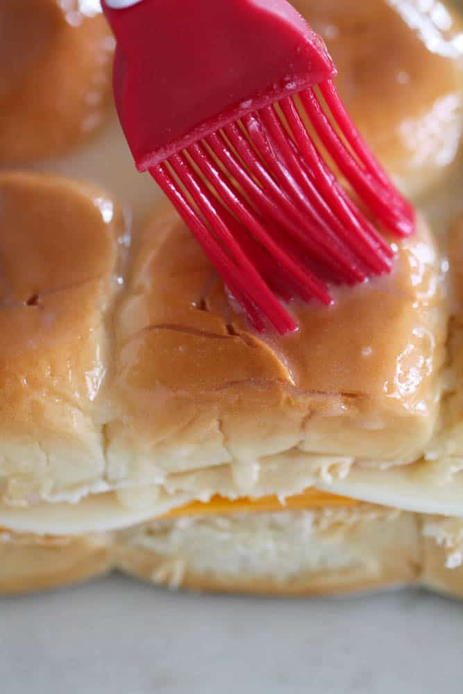 Brushing butter on Grilled Cheese Sliders