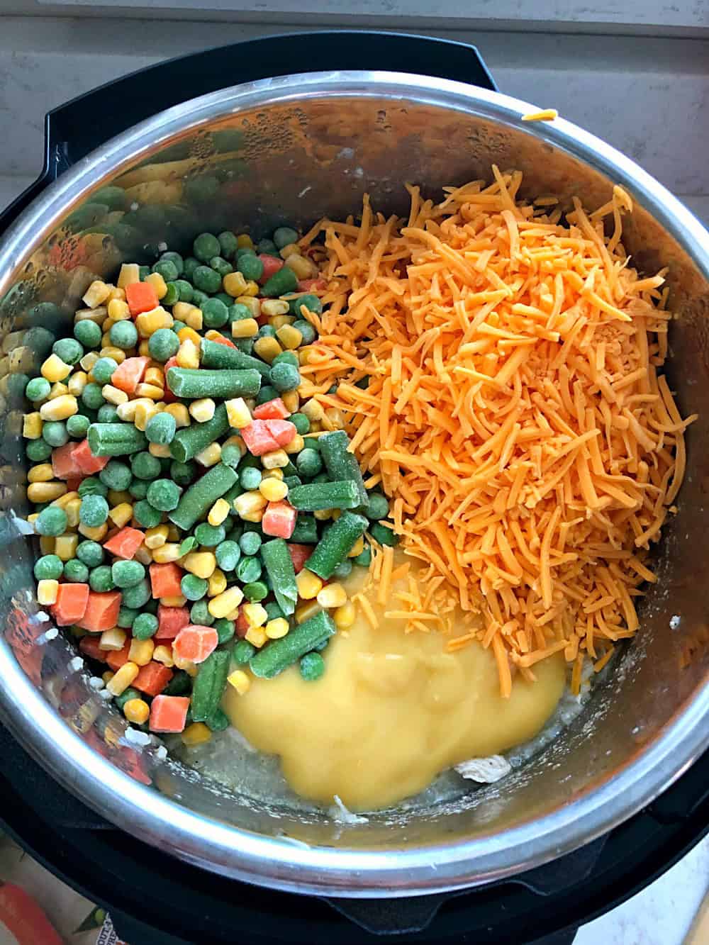 frozen vegetables, cheese, and chicken soup dumped into an instant pot