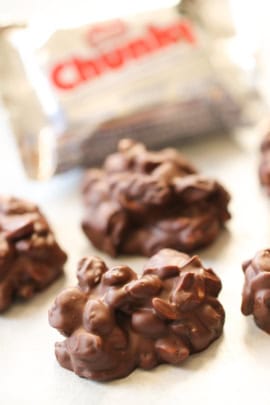 Copycat Chunky Bar Clusters on parchment paper with a Chunky Bar candy wrapped in the background.