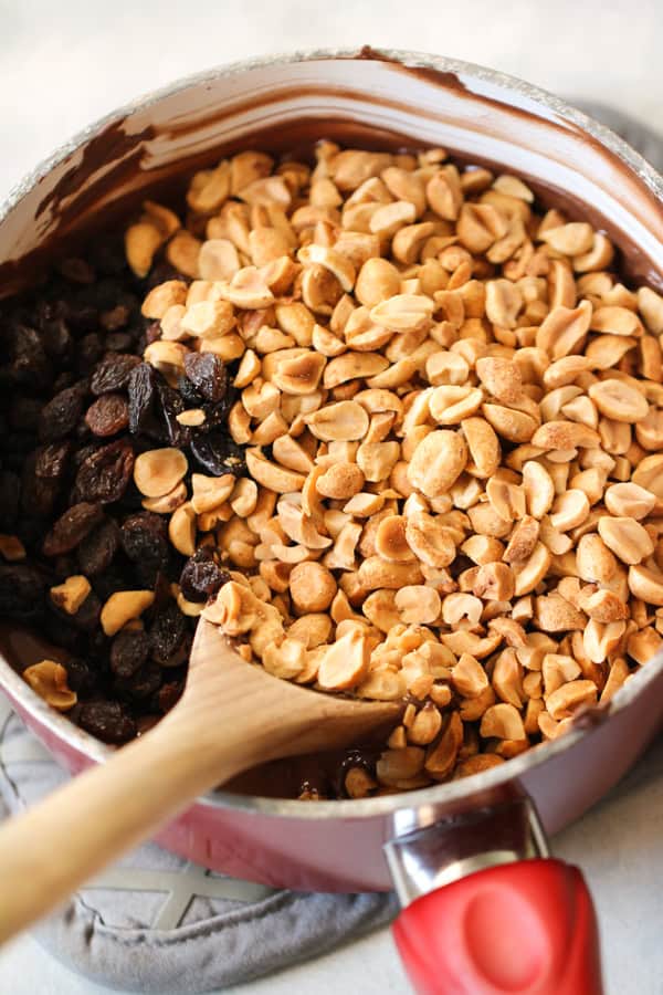 A sauce pan with nuts, raisins and chocolate