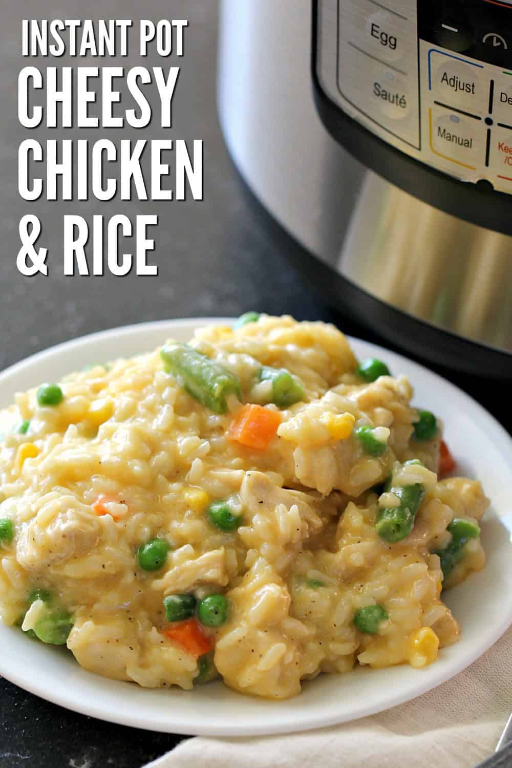 cheesy chicken and rice with mixed vegetables on a plate next to an Instant Pot