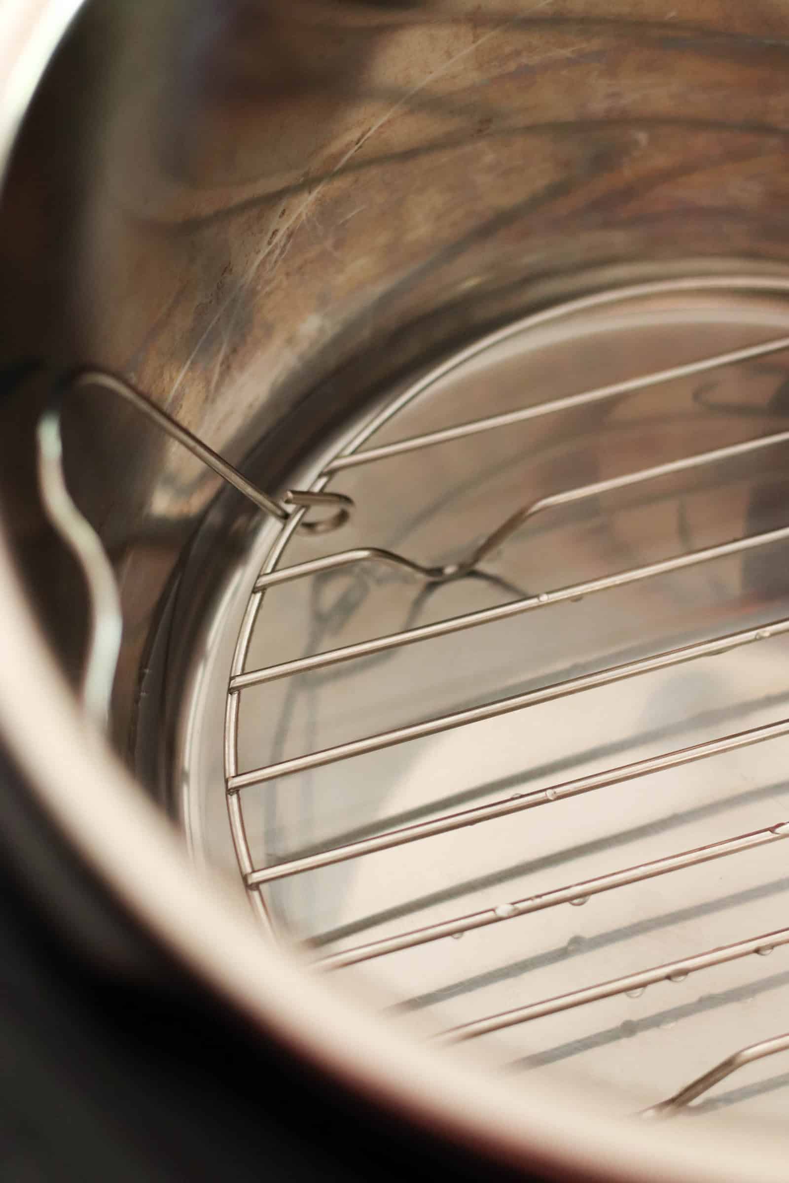 Instant pot with steamer rack and water inside.