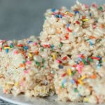 A plate with 3 Creamy Funfetti Cake Batter Rice Krispie Treats.
