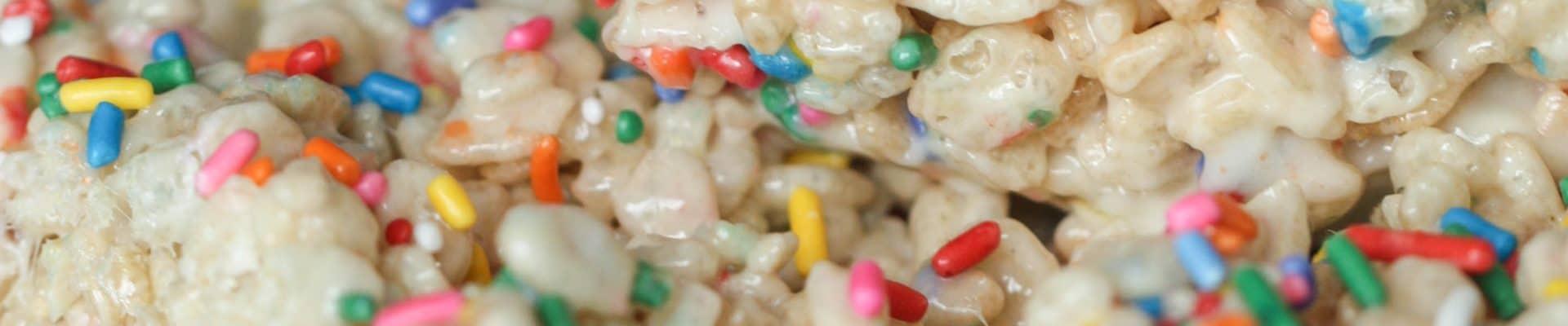 A plate with 3 Creamy Funfetti Cake Batter Rice Krispie Treats.