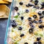 Skinny Taco Dip in a baking dish with chips on the side.