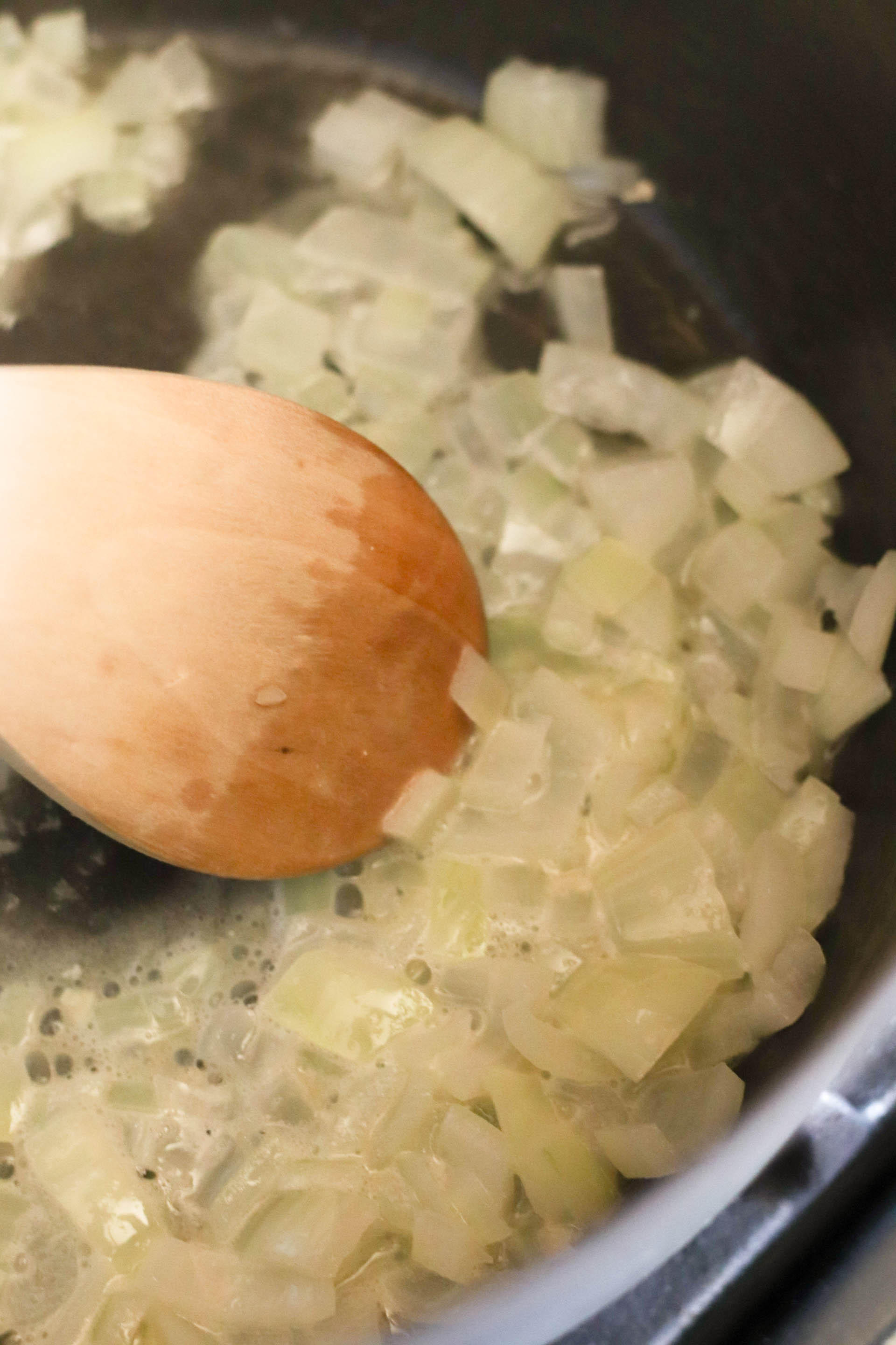 Onions sautéing in a sauce pot