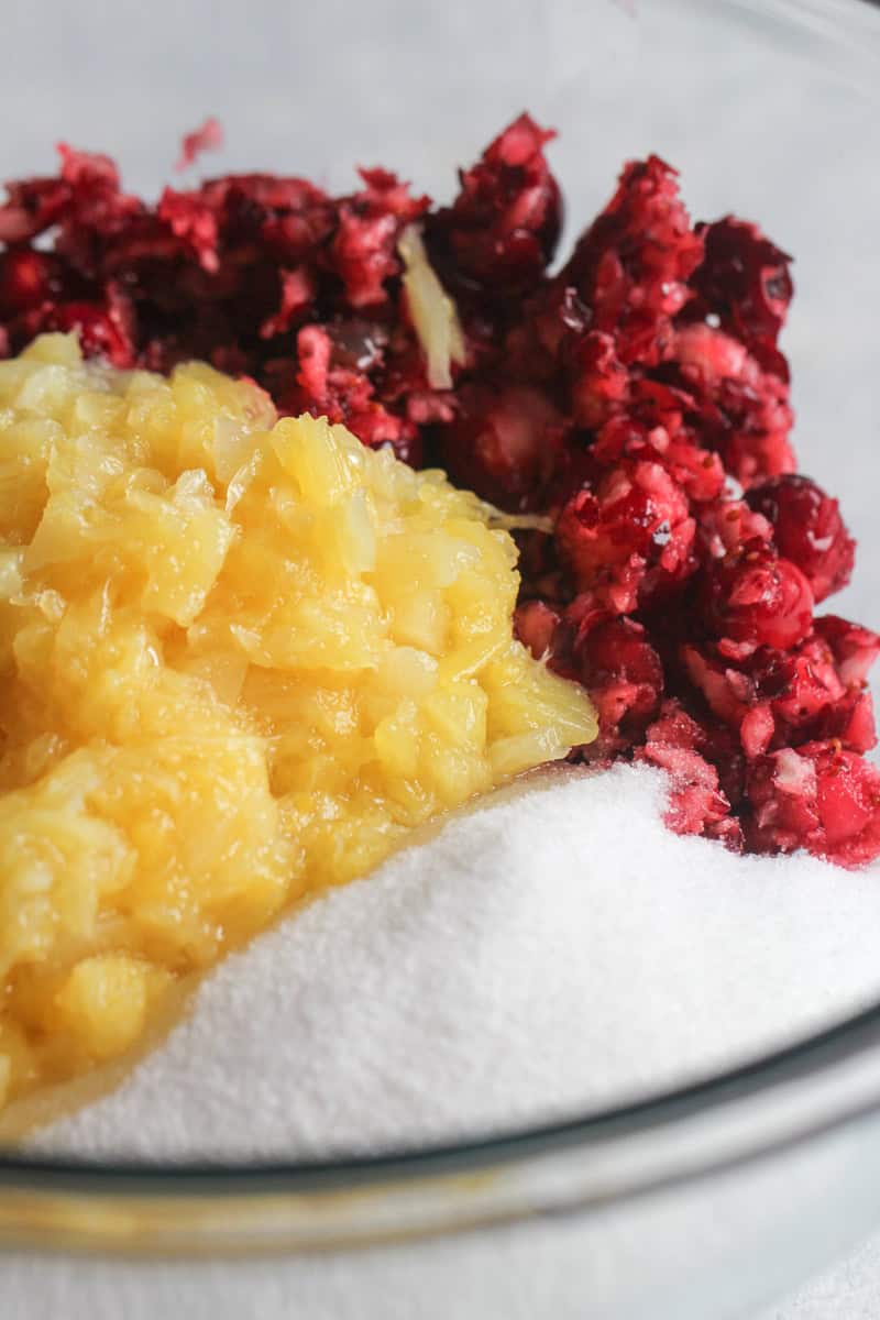 Chopped Cranberries, pineapple and sugar in a mixing bowl