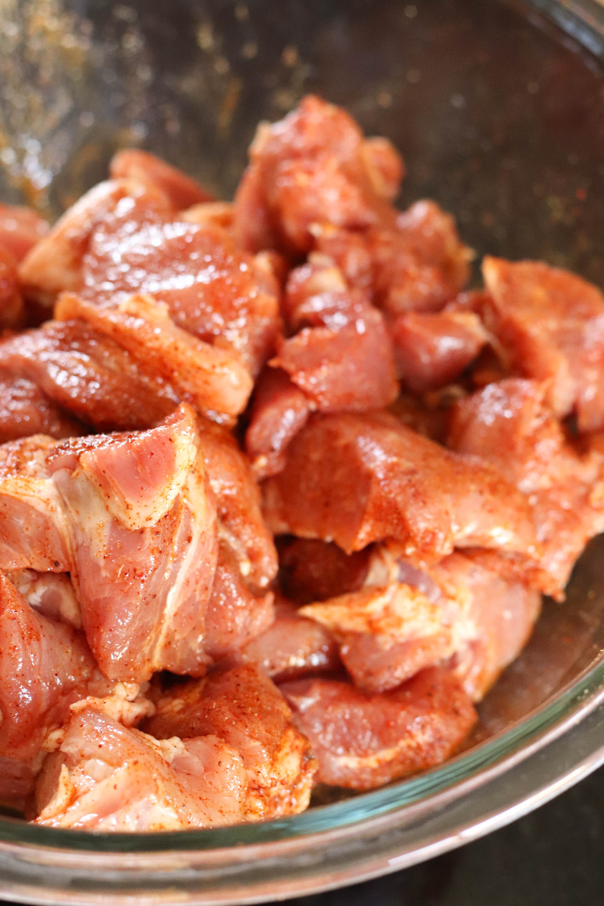 Pork tossed with carnita seasoning in a bowl