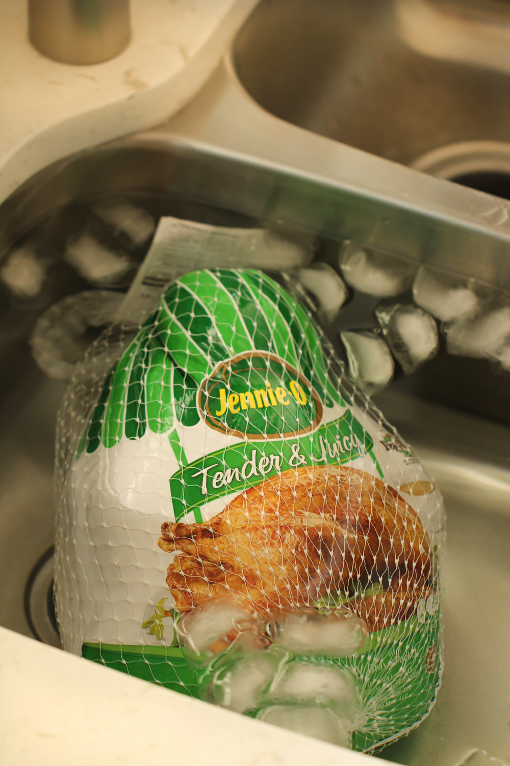 turkey defrosting in sink of cold icy water for six sisters stuff