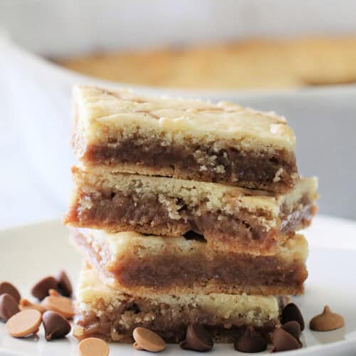 4 Cake Mix Cookie Bars cut into squares on a white plate.