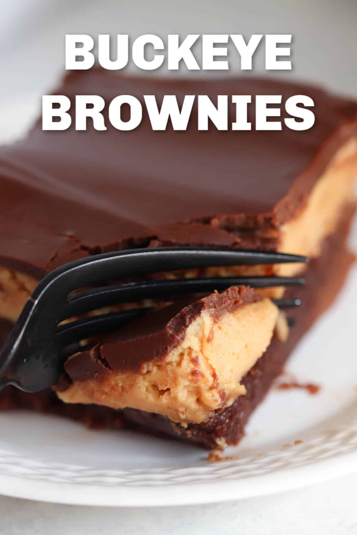 One Buckeye Brownie square on a white plate with a fork