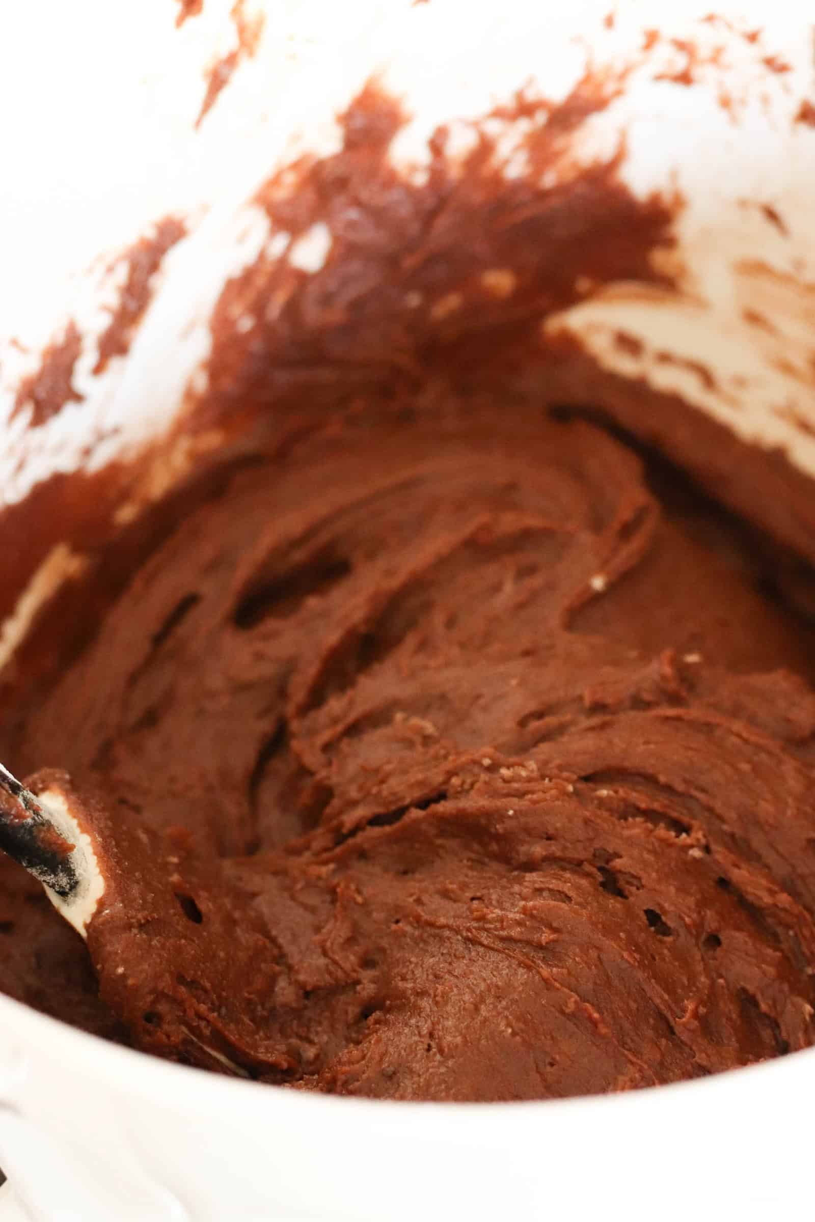 Brownie mixture in mixing bowl with a rubber spatula