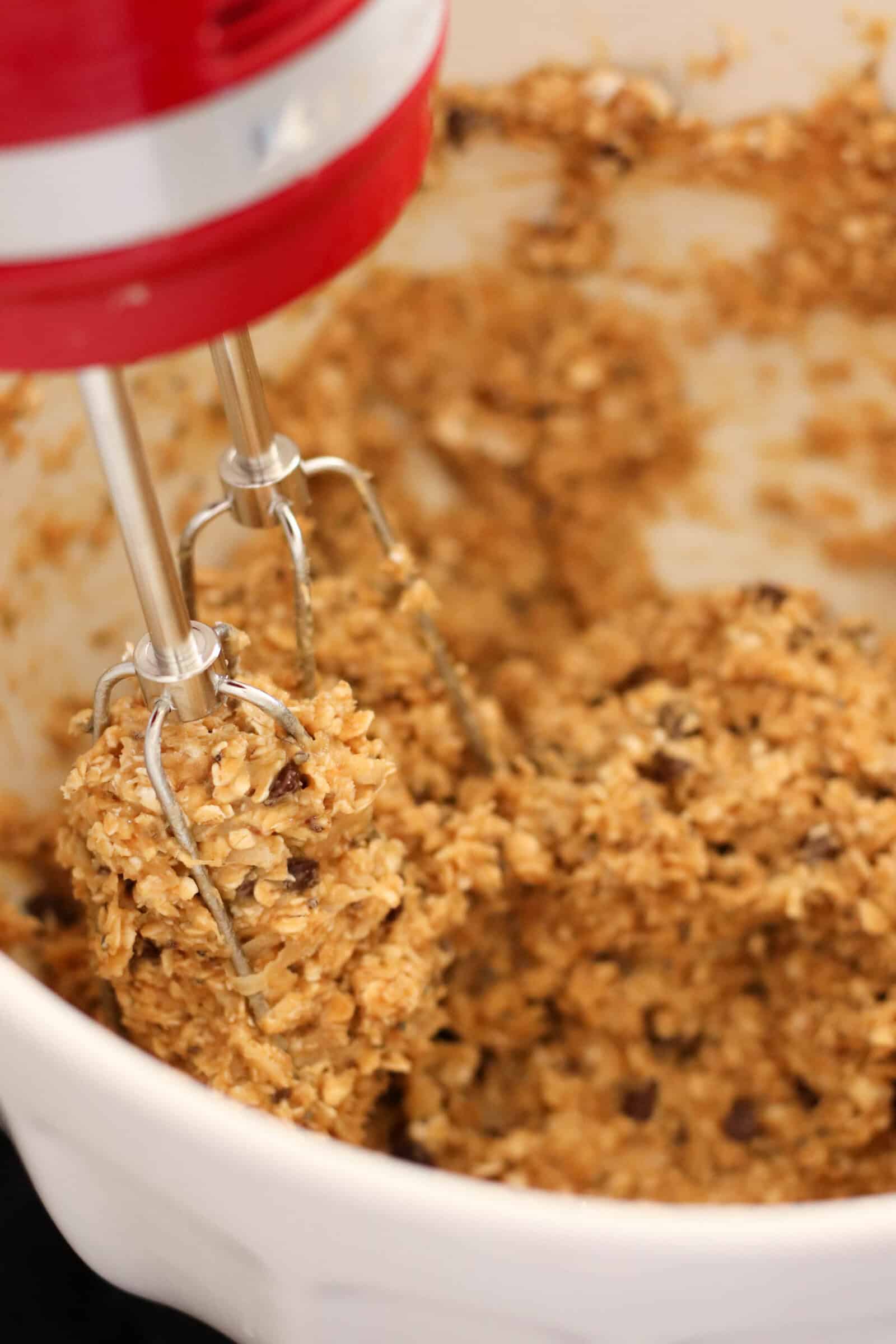 Cookie dough for Breakfast Cookies in a mixing bowl with a hand mixer