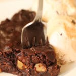 Instant Pot Fudgy Brownie on a plate with a fork in it, served with a scoop of icecream.