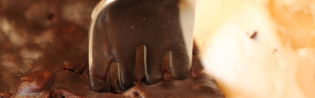 Instant Pot Fudgy Brownie on a plate with a fork in it, served with a scoop of icecream.