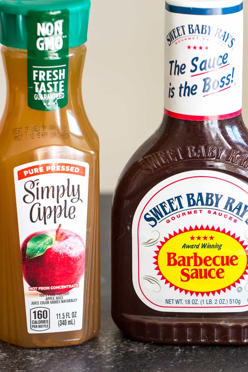 A bottle of Apple Juice and a bottle of BBQ sauce