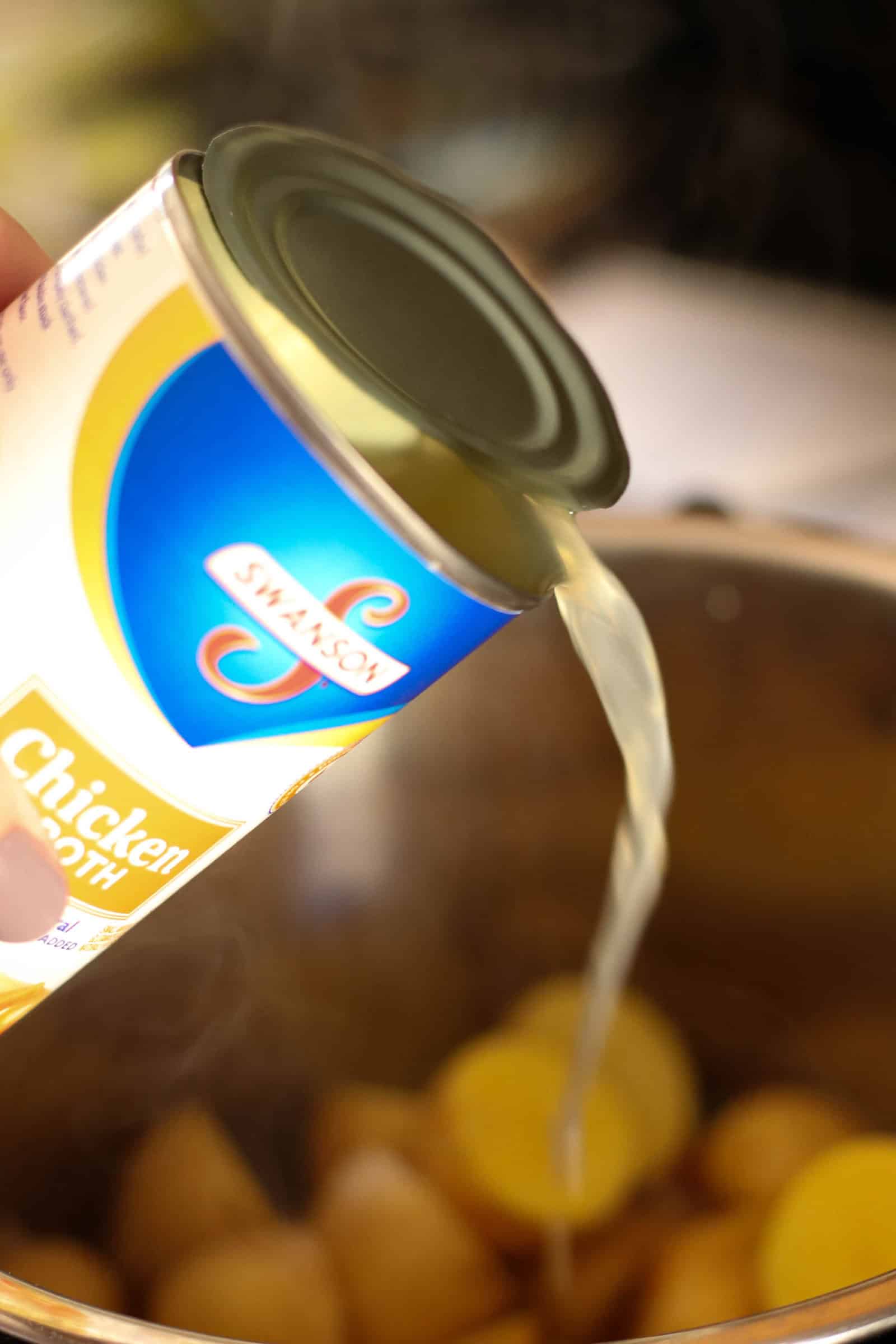 Pouring chicken broth into the Instant Pot